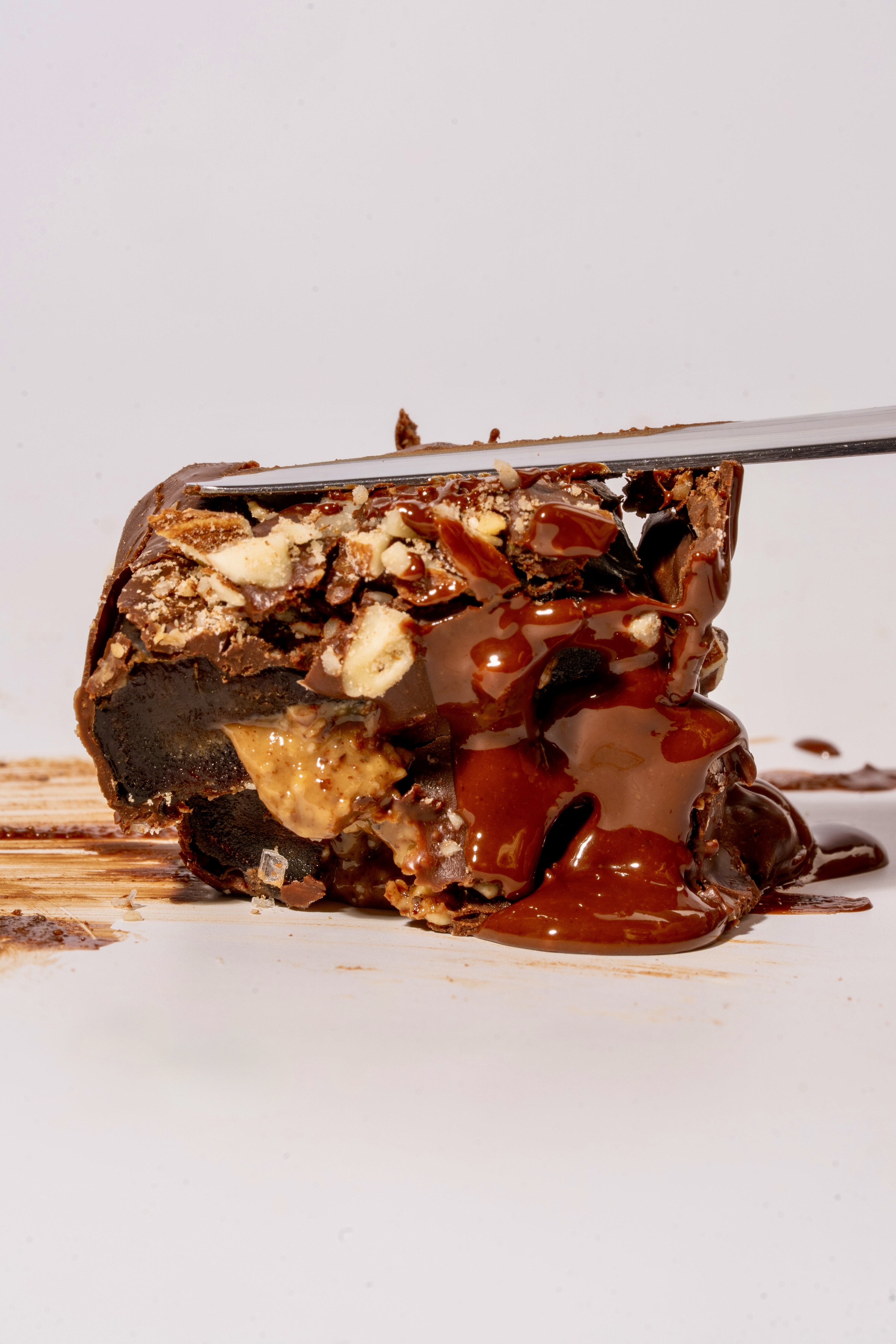 The Almond — knife cutting through, showing golden almond butter cross-section